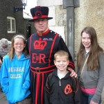 From left: the preteen, the kid, and the teen with a Tower of London Beefeater